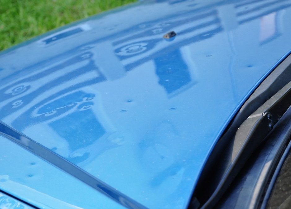 hail damage on blue car hood